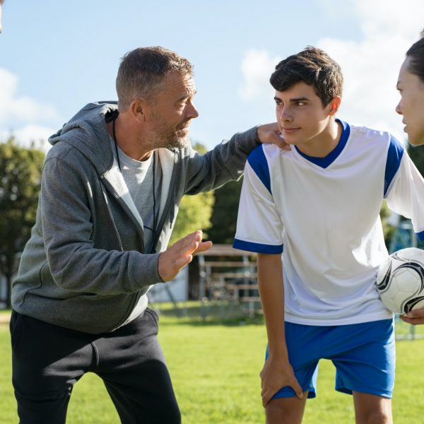 Coach talking to young soccer team before the match